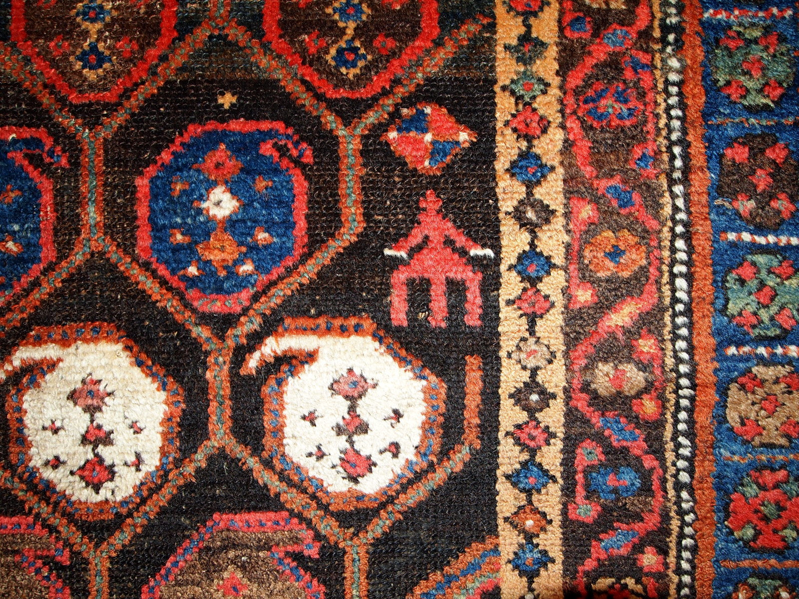 Antique Persian Kurdish rug in chocolate brown shade with repeating pattern. This rug is in original good condition.
