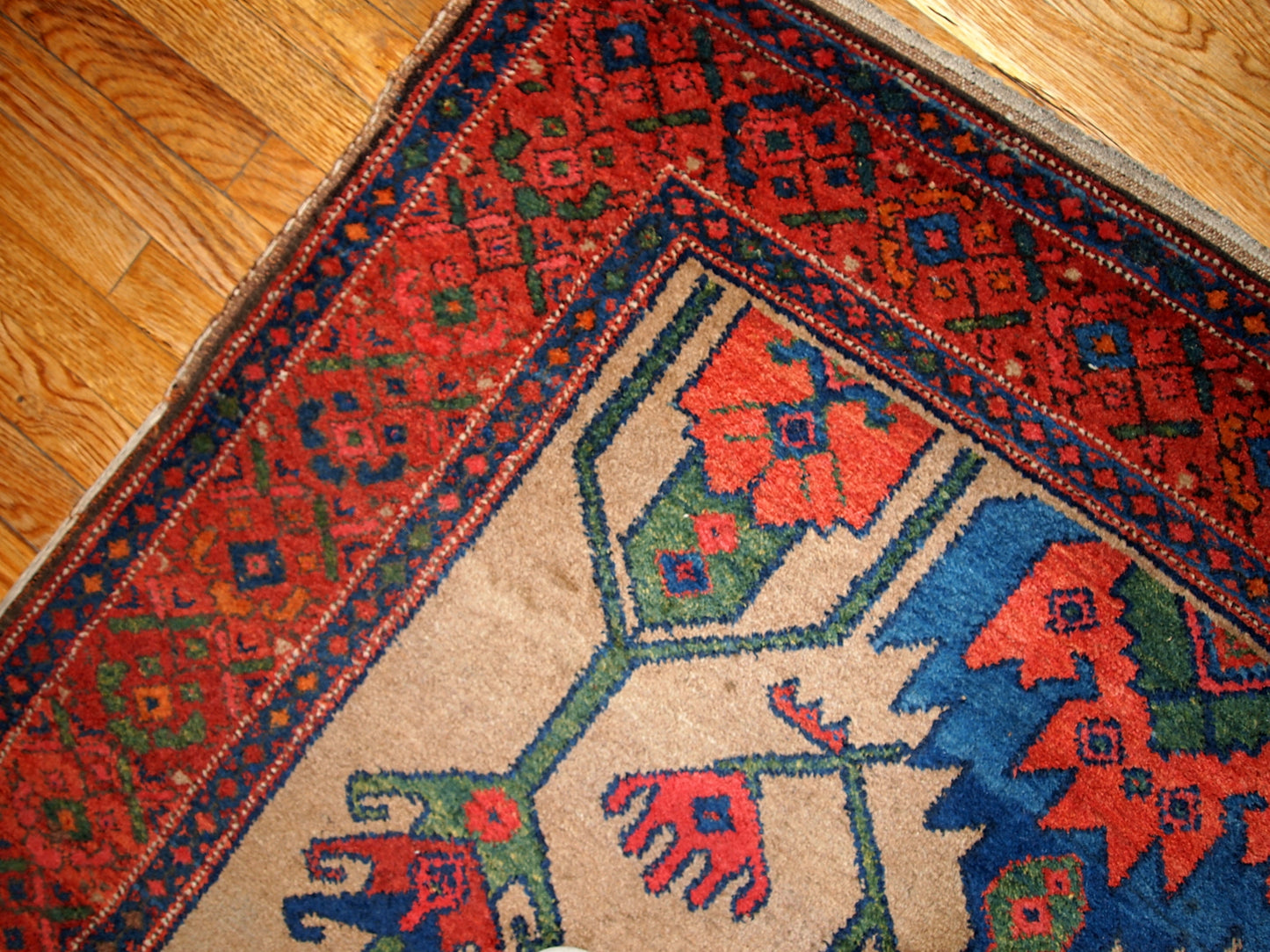 Antique Persian Kurdish rug in light brown background color. Very primitive tribal design with large ornaments. The rug is in original good condition.
