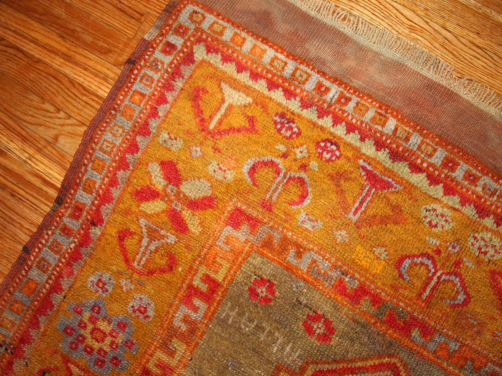 Antique Turkish Anatolian rug in soft tones of green, orange, red and brown.  The rug is from the beginning of 20th century and in original good condition.