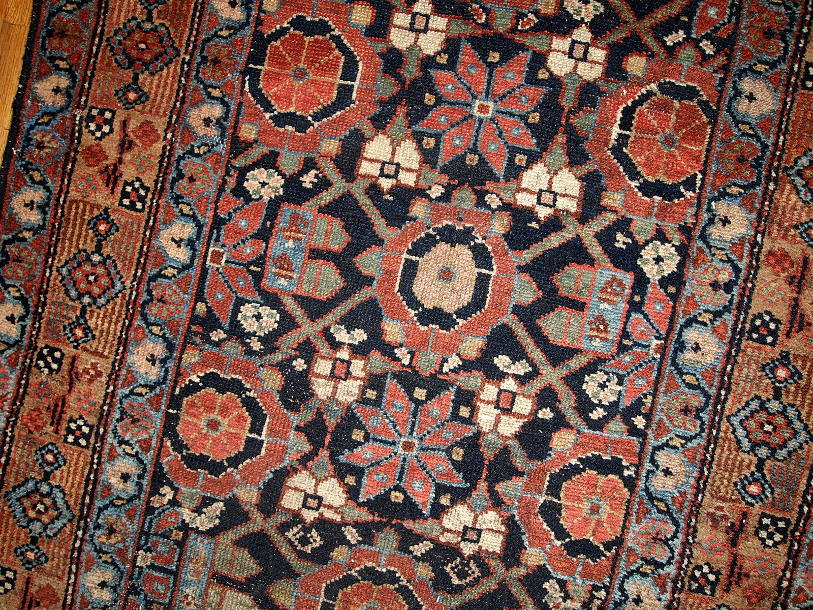 Antique Persian Hamadan runner in good original condition. This rug is in black and red shades.