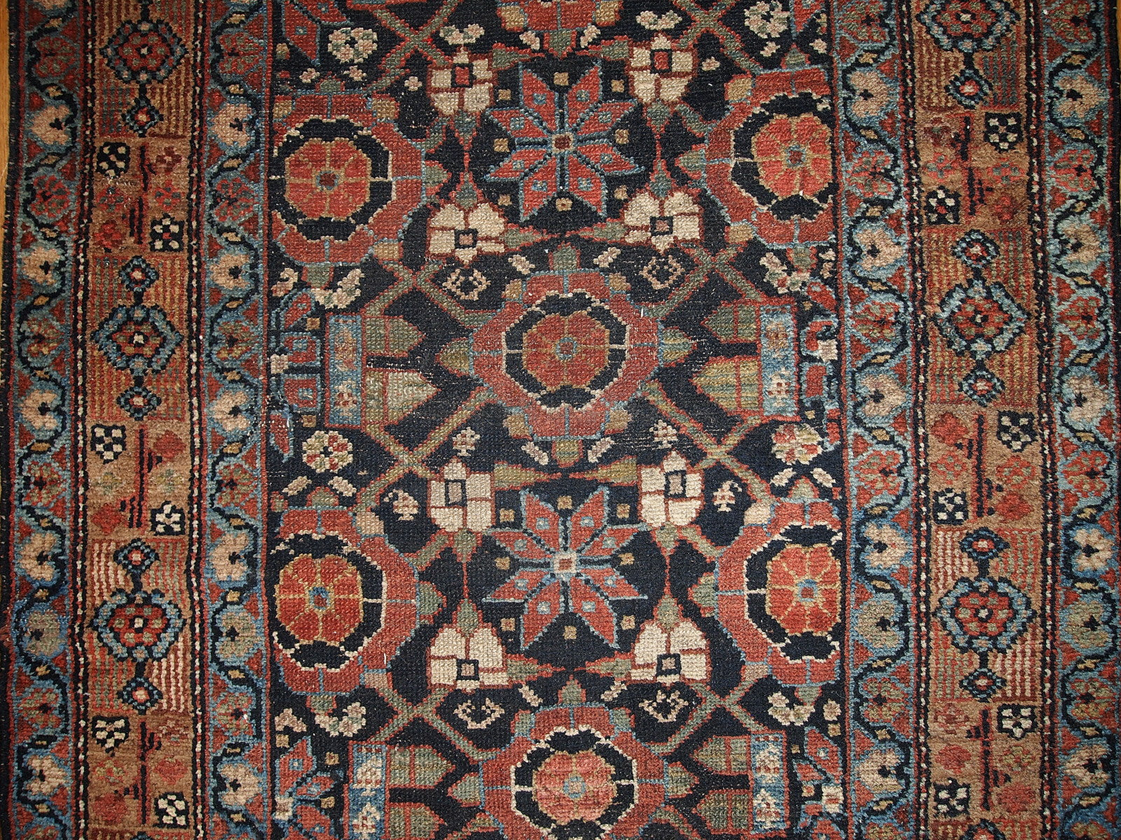 Antique Persian Hamadan runner in good original condition. This rug is in black and red shades.