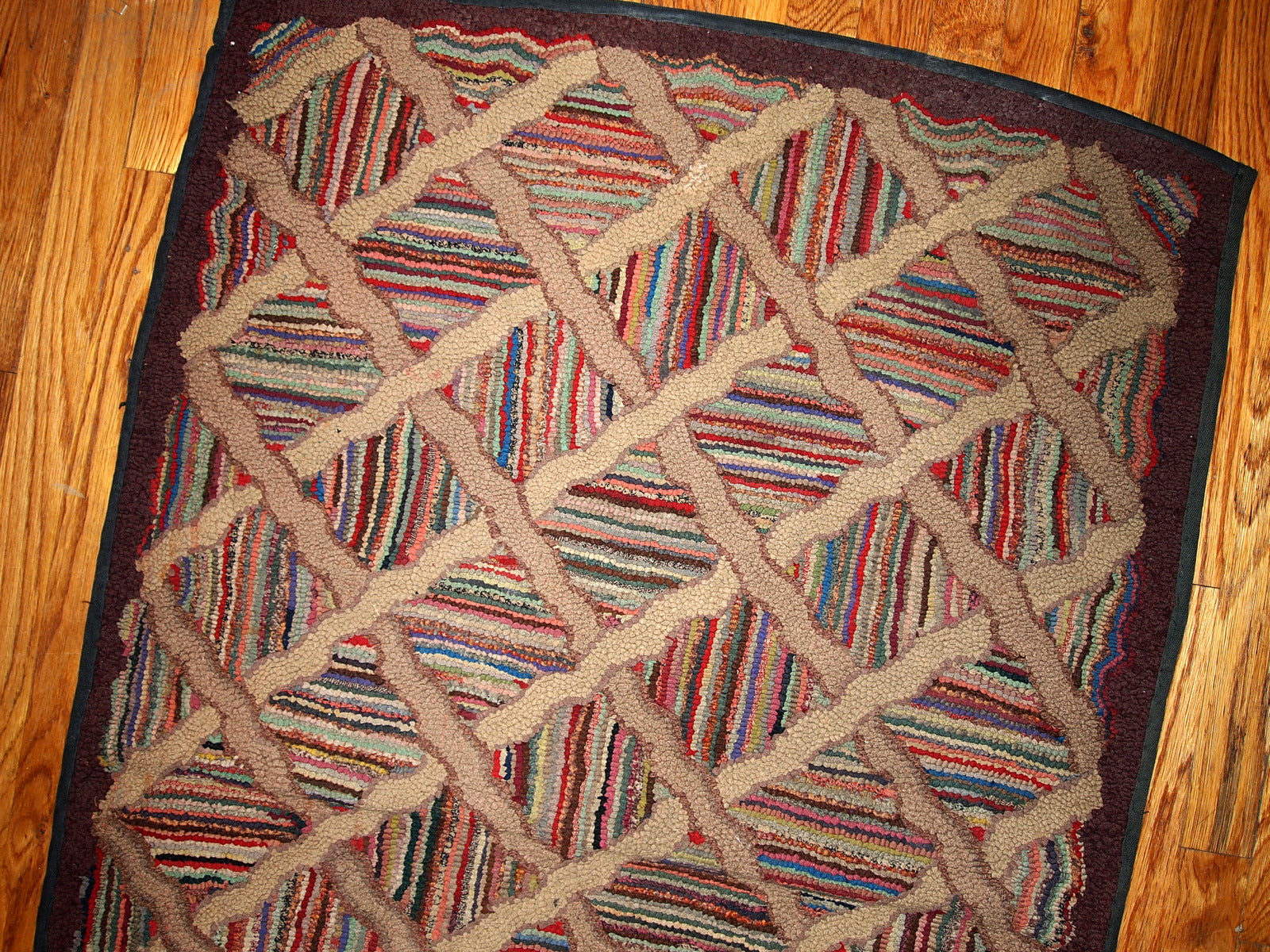 Antique hand hooked American runner in original good condition from the end of 19th century. This rug made in multiply colours and geometric design.