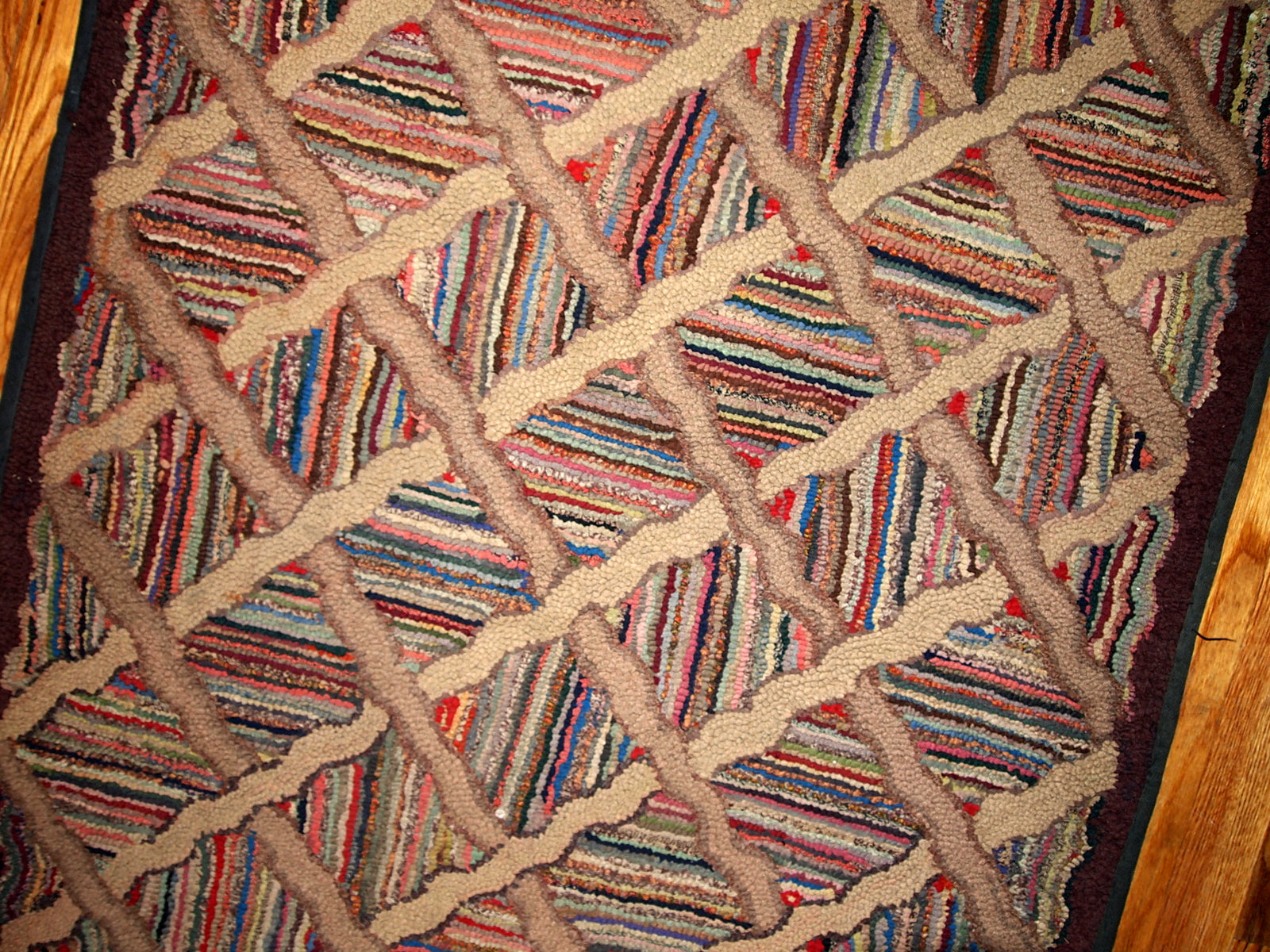 Antique hand hooked American runner in original good condition from the end of 19th century. This rug made in multiply colours and geometric design.