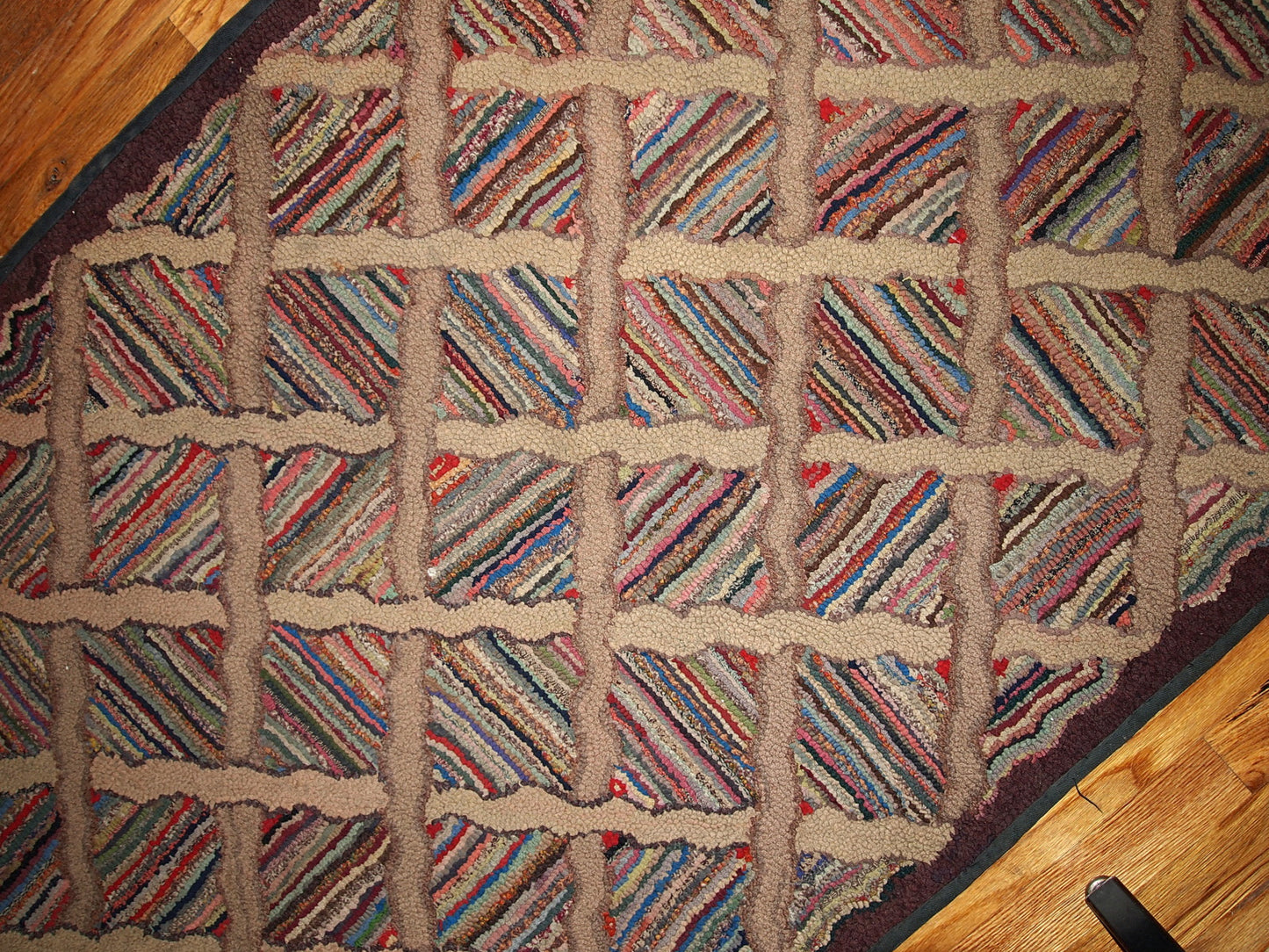 Antique hand hooked American runner in original good condition from the end of 19th century. This rug made in multiply colours and geometric design.