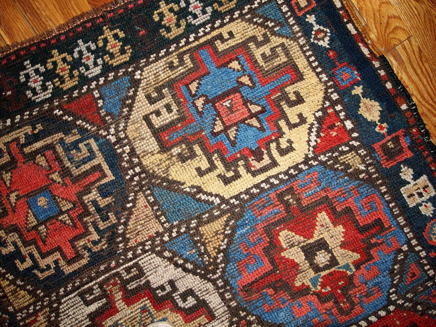 Antique collectible Kurdish rug in colorful shades and tribal ornaments. The rug is in a good shape for it's age, has some age wear. 