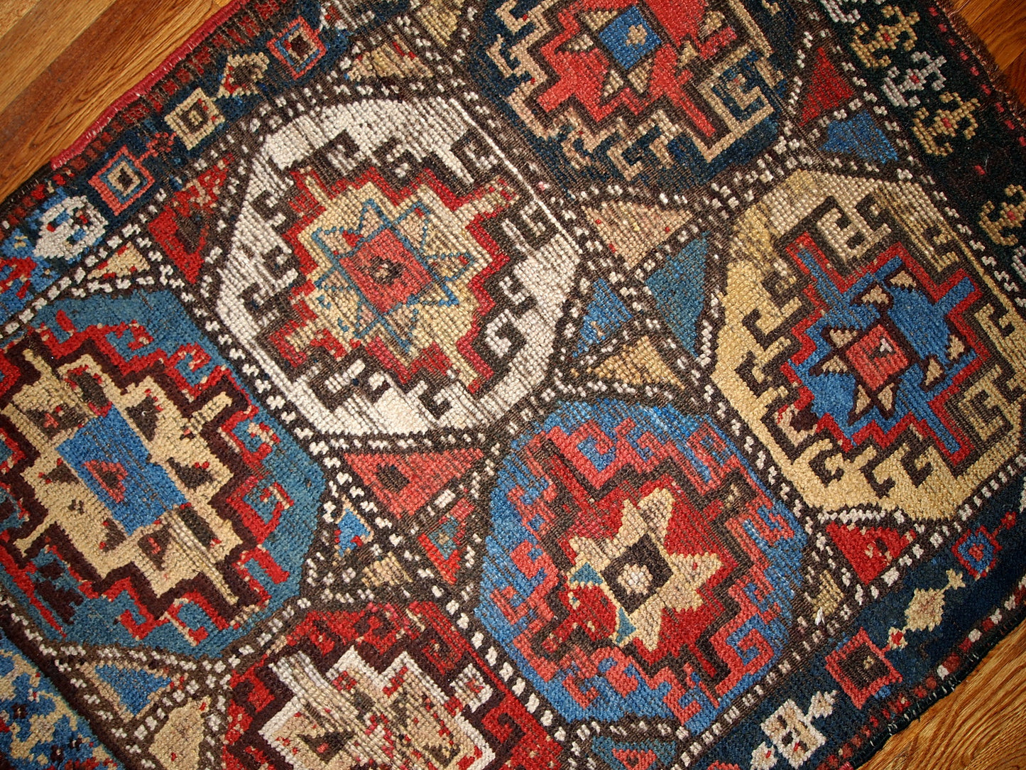 Antique collectible Kurdish rug in colorful shades and tribal ornaments. The rug is in a good shape for it's age, has some age wear. 
