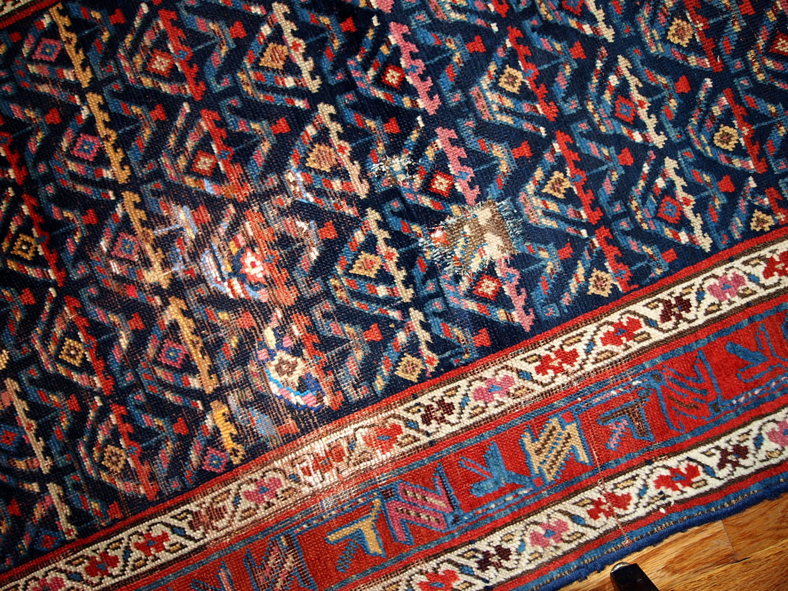 Antique hand made Persian Kurdish distressed runner in dark blue shade. The rug has some age damages and a patch.