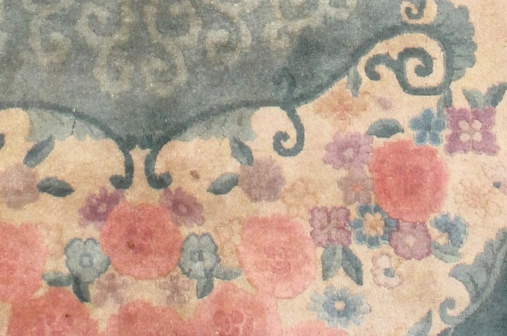 Oval Art Deco Chinese rug in original good condition. The rug is in green, rose and beige shades.