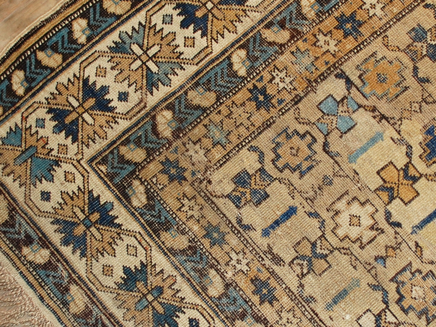 Antique hand made Caucasian Shirvan rug in original condition, it has some low pile. The rug is in light shades of brown, beige and azure colors.