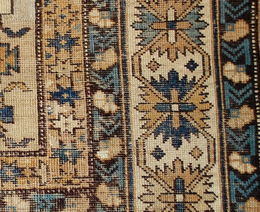 Antique hand made Caucasian Shirvan rug in original condition, it has some low pile. The rug is in light shades of brown, beige and azure colors.
