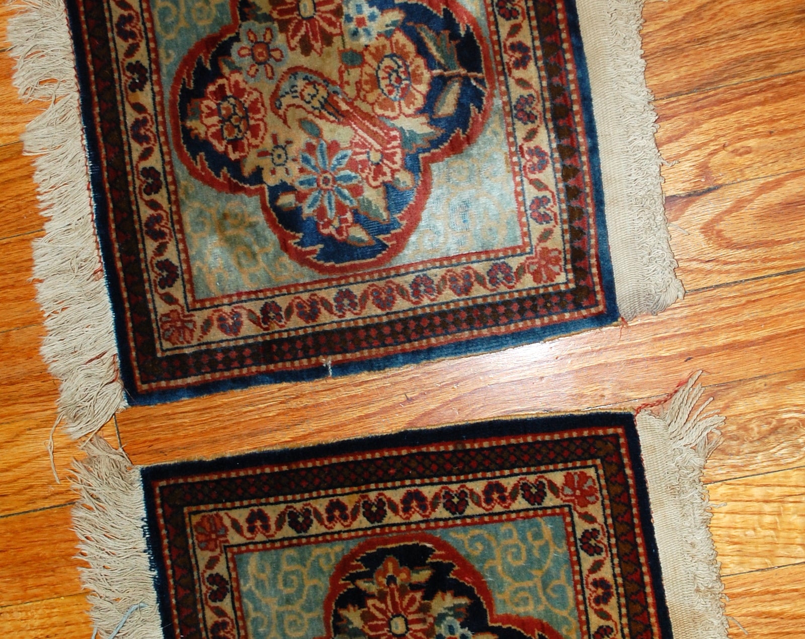 Hand made pair of antique Persian collectible Dabir Kashan rugs in original good condition. The rugs has classy Dabir Kashan design with medallion in the shape of four petals flower and the bird in it surrounded by flowers. 