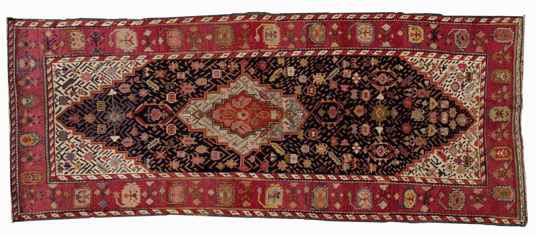 Antique hand made Armenian Karabagh rug in good condition. The rug has been made in the end of 19th century in black and pink wool.