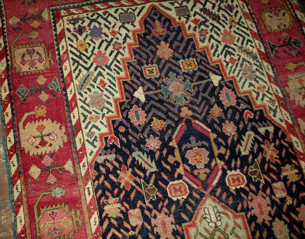 Antique hand made Armenian Karabagh rug in good condition. The rug has been made in the end of 19th century in black and pink wool.