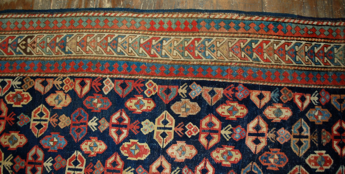 Antique handmade Caucasian Gendje rug in good condition. The rug has dark blue field covered in tribal figures, made in the end of 19th century.