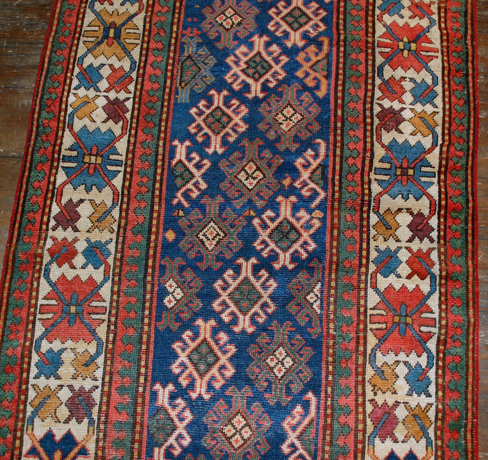 Antique handmade Caucasian Gendje rug in good condition. The rug is from the end of 19th century, made in Russia.
