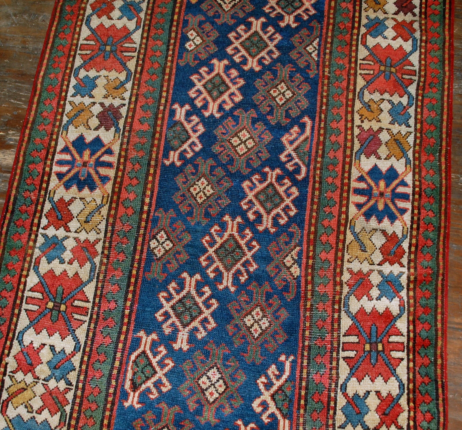 Antique handmade Caucasian Gendje rug in good condition. The rug is from the end of 19th century, made in Russia.