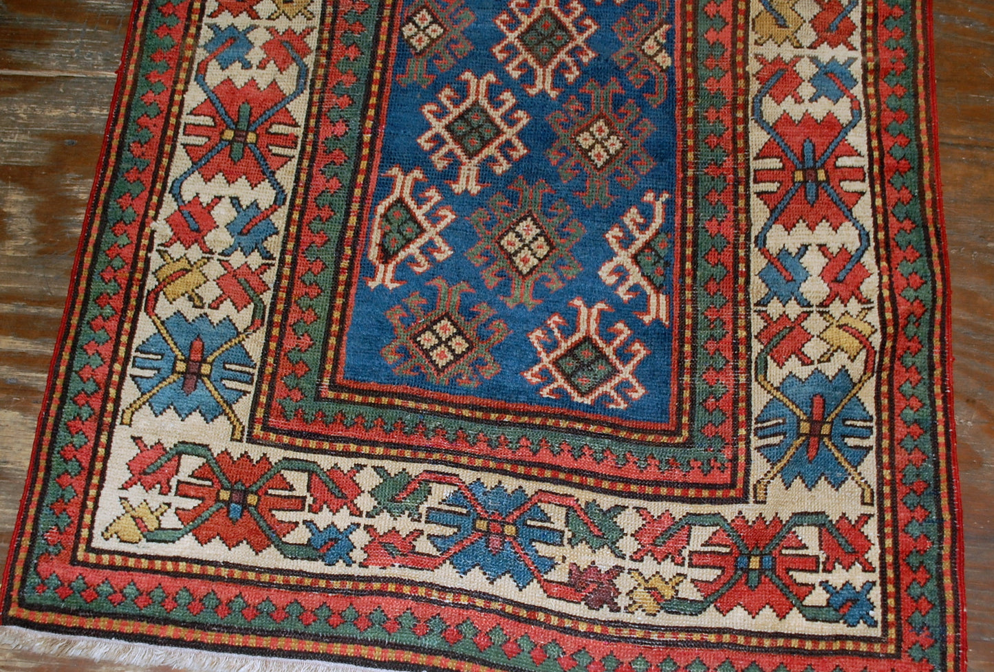 Antique handmade Caucasian Gendje rug in good condition. The rug is from the end of 19th century, made in Russia.