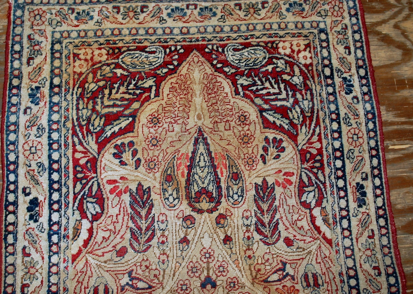 Persian Kerman Lavar rug in original condition, it has some low pile. The rug is prayer in beige and burgundy shades, made in the end of 19th century.