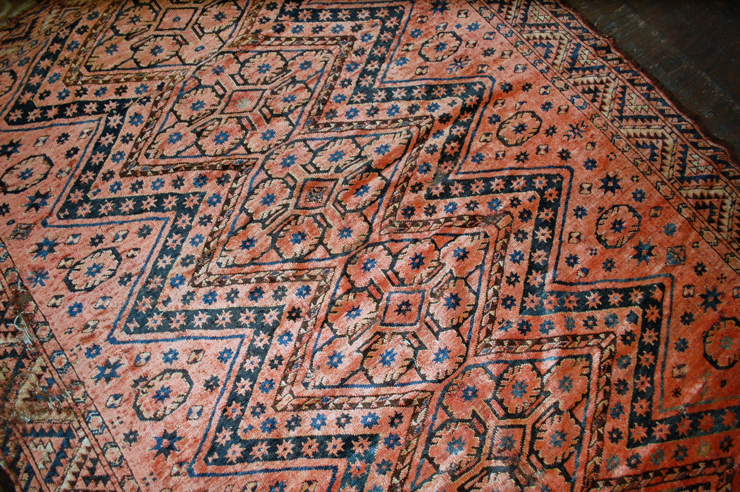 Antique collectible Uzbek Beshir rug in original condition, it has some holes. The rug made in red color and tribal design in the beginning of 20th century.