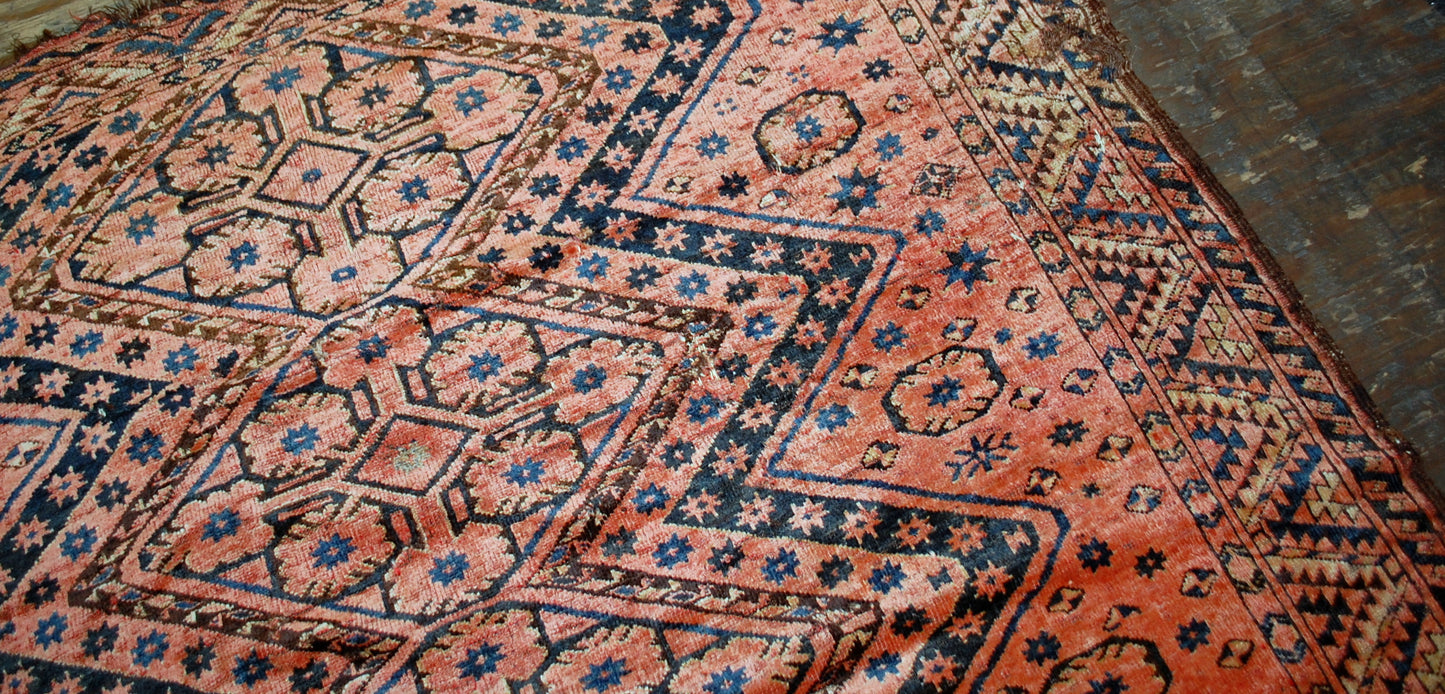 Antique collectible Uzbek Beshir rug in original condition, it has some holes. The rug made in red color and tribal design in the beginning of 20th century.