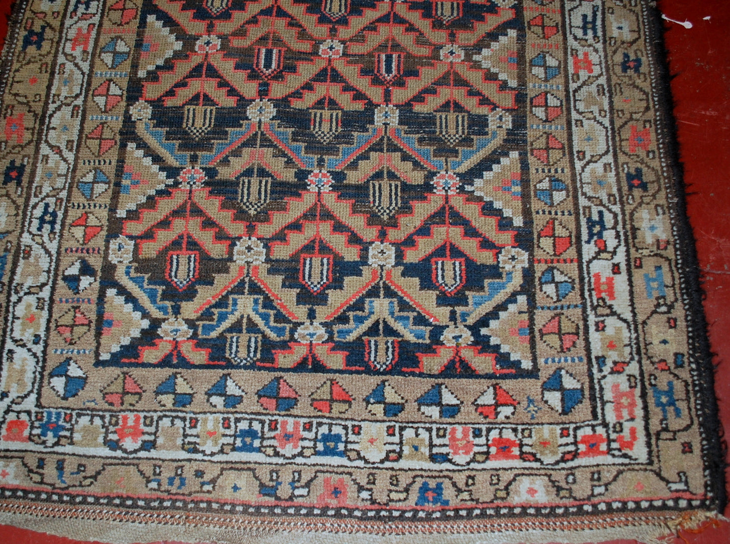 Antique Persian Hamadan rug in original condition, it has some low pile. The rug is from the Middle East region made in the beginning of 20th century.