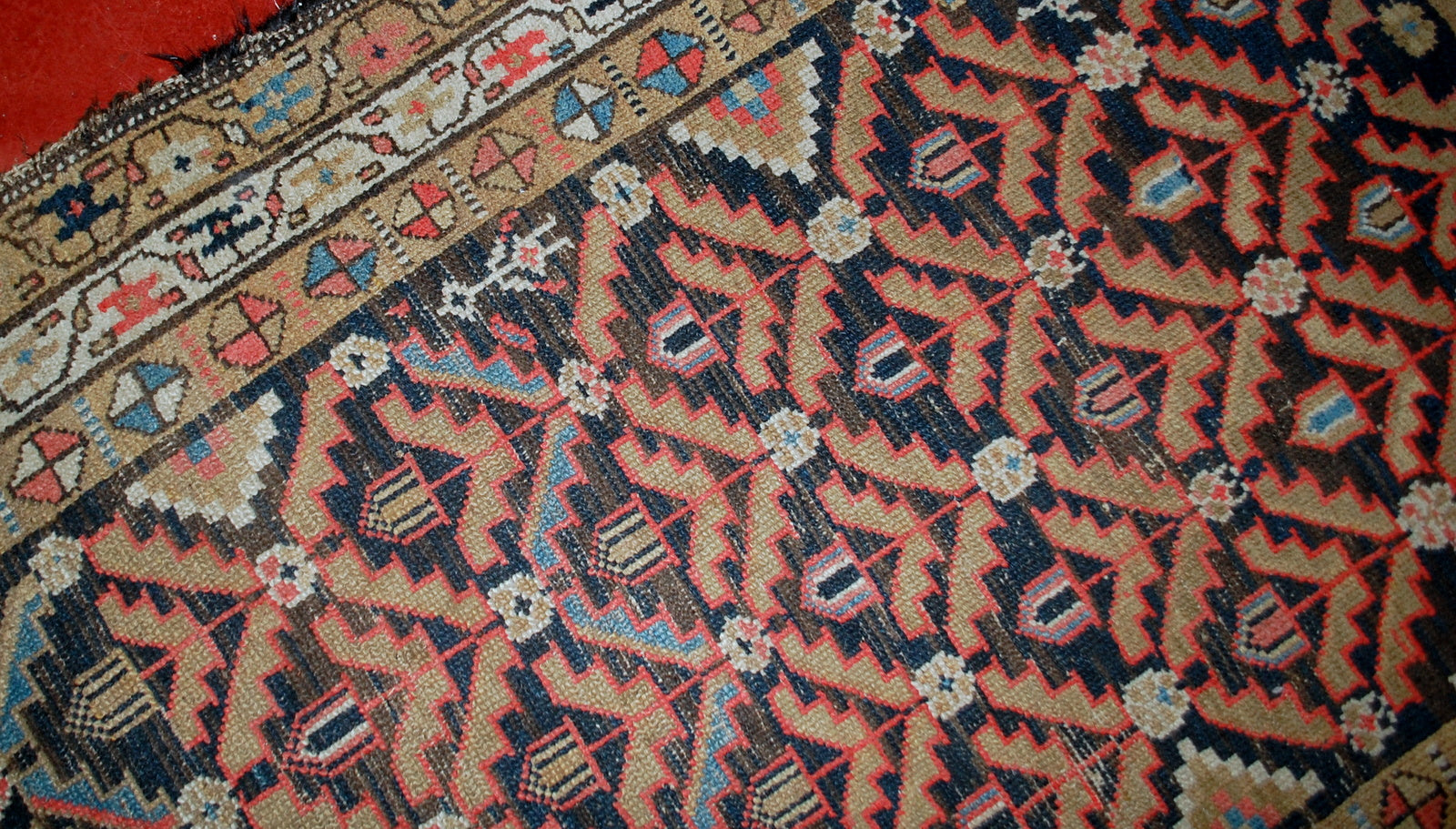 Antique Persian Hamadan rug in original condition, it has some low pile. The rug is from the Middle East region made in the beginning of 20th century.