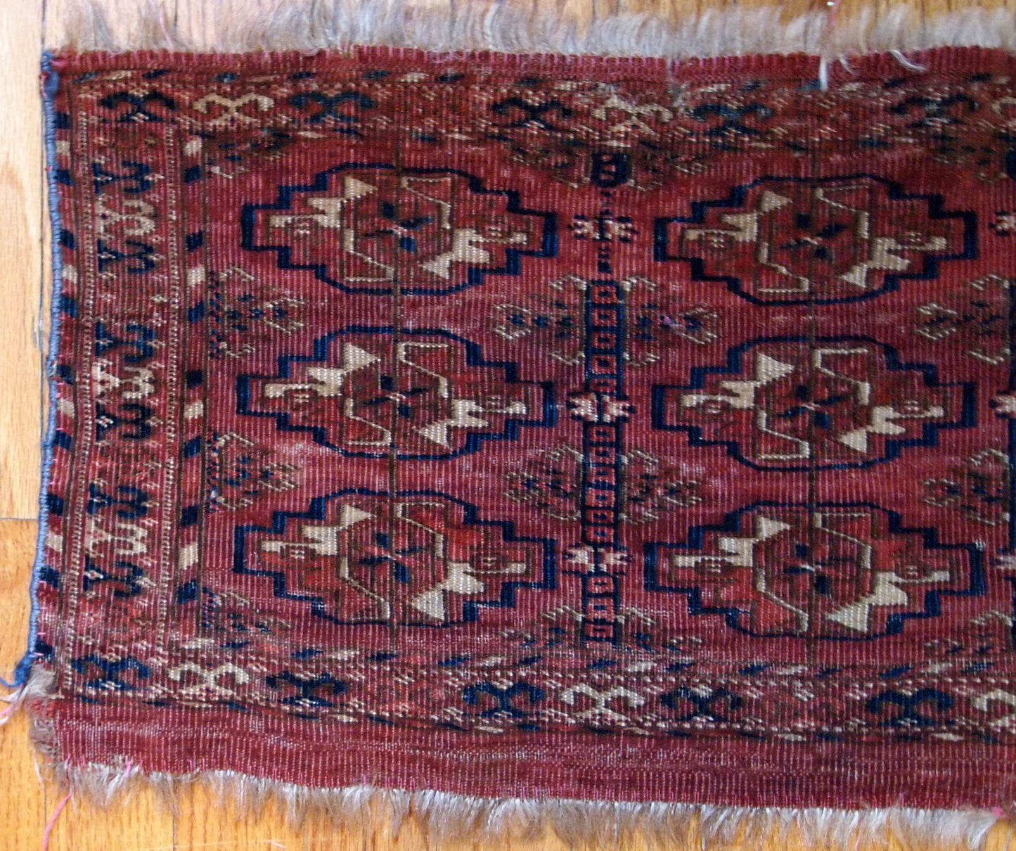 Antique Turkmen Tekke Torba in unusually small size. It is from the middle of 19th century, has some low pile.