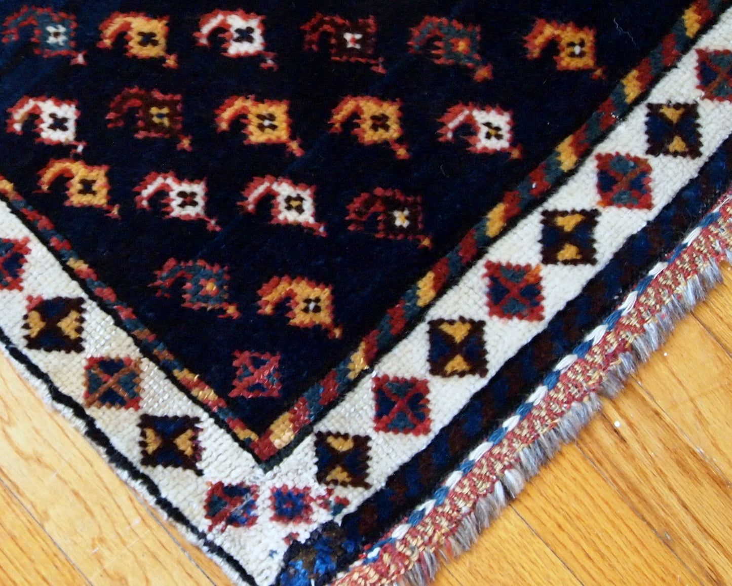 Antique collectible Persian Luri bagface in original good condition. Navy blue background with a slight abrash and colorful pattern in yellow, red and pink shades.