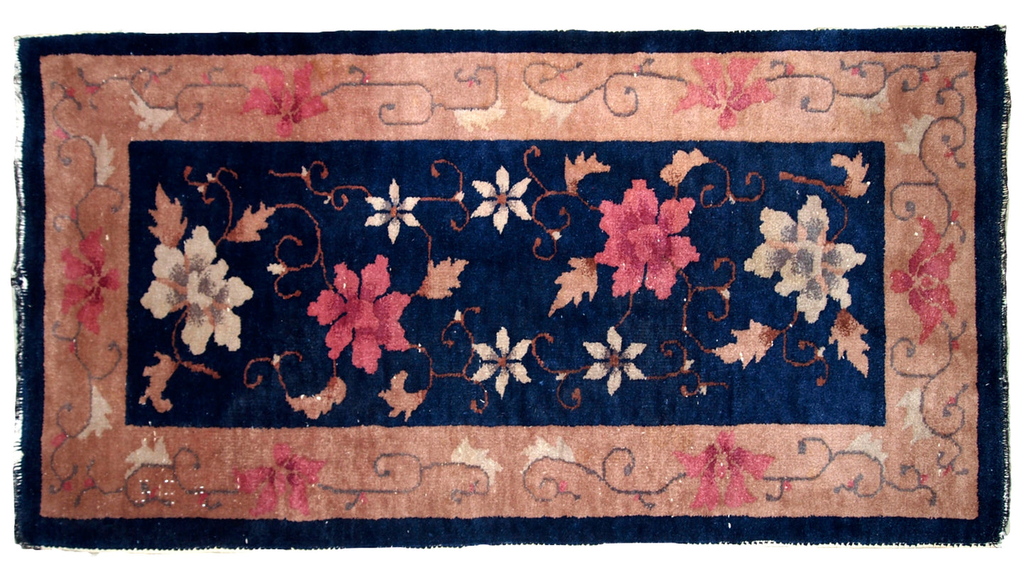 Art Deco Chinese rug in original good condition. The rug is in navy blue shade with peach border. 