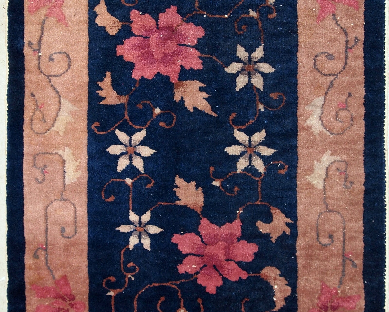 Art Deco Chinese rug in original good condition. The rug is in navy blue shade with peach border. 