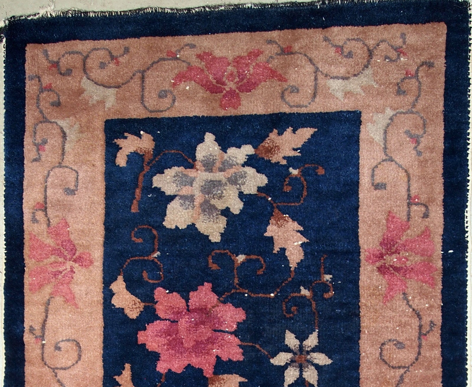 Art Deco Chinese rug in original good condition. The rug is in navy blue shade with peach border. 
