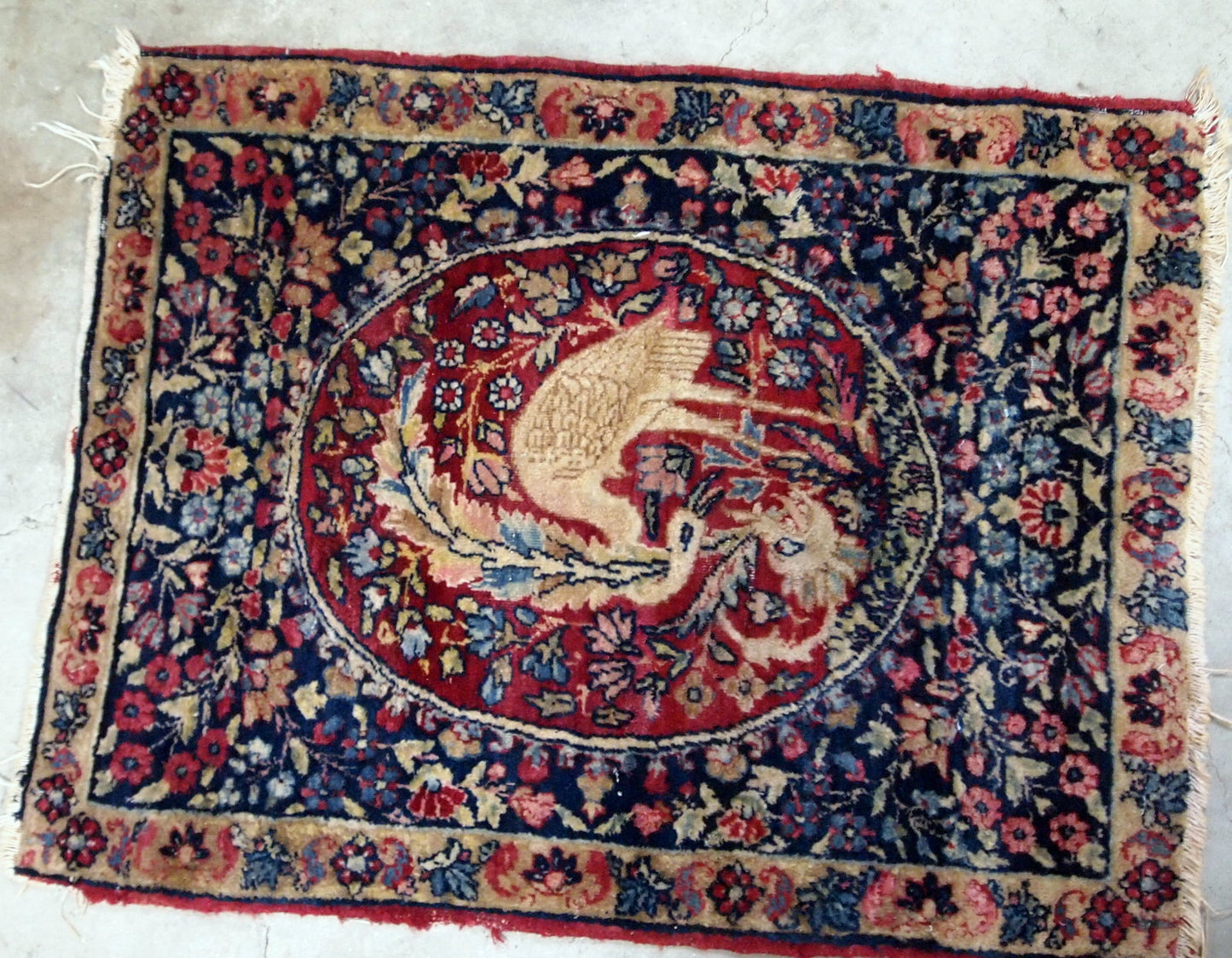 Handmade antique Persian Kerman Lavar collectible rug with bird. It is in original condition, the ends are missing and some low pile. The rug is from the end of 19th century.