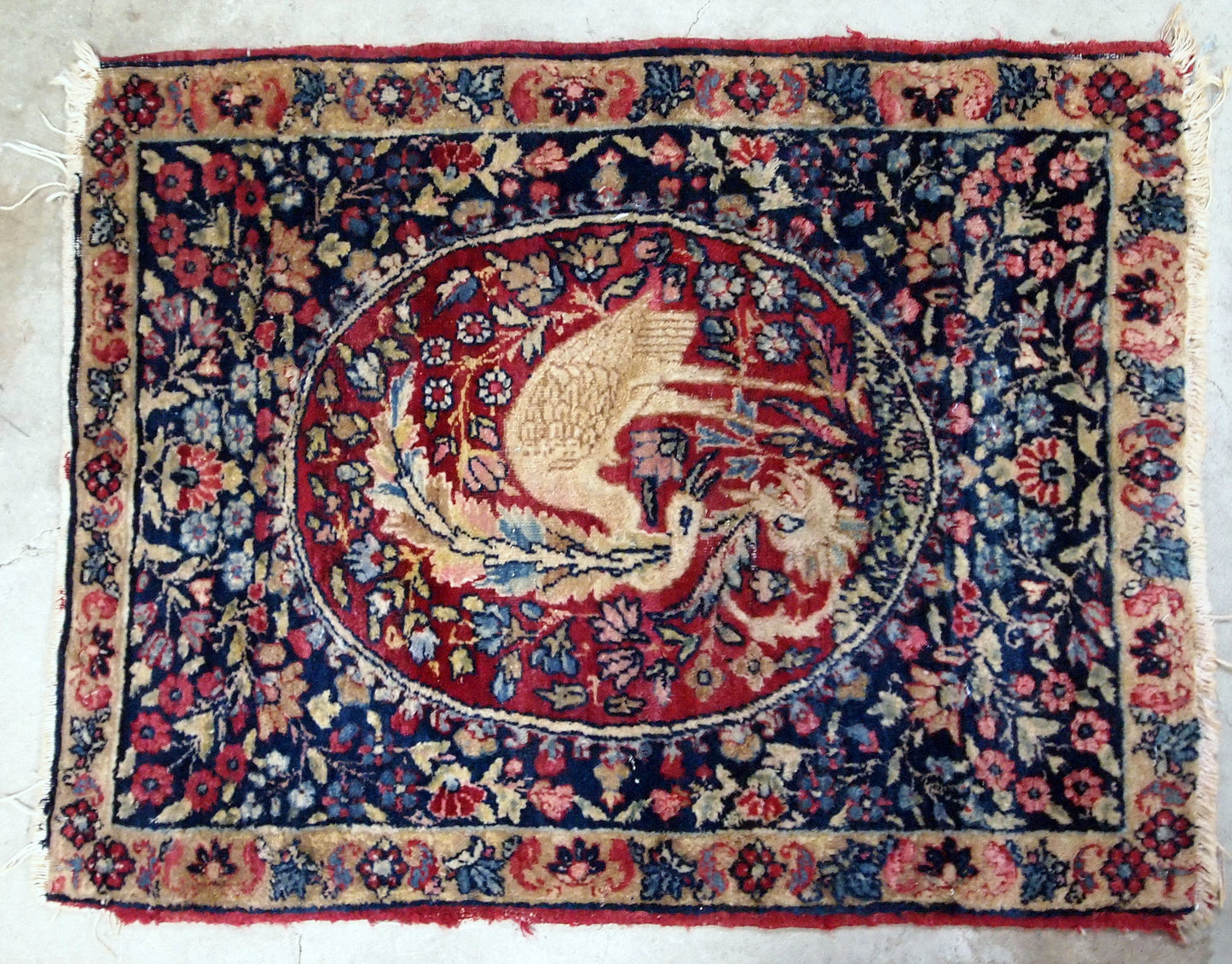 Handmade antique Persian Kerman Lavar collectible rug with bird. It is in original condition, the ends are missing and some low pile. The rug is from the end of 19th century.