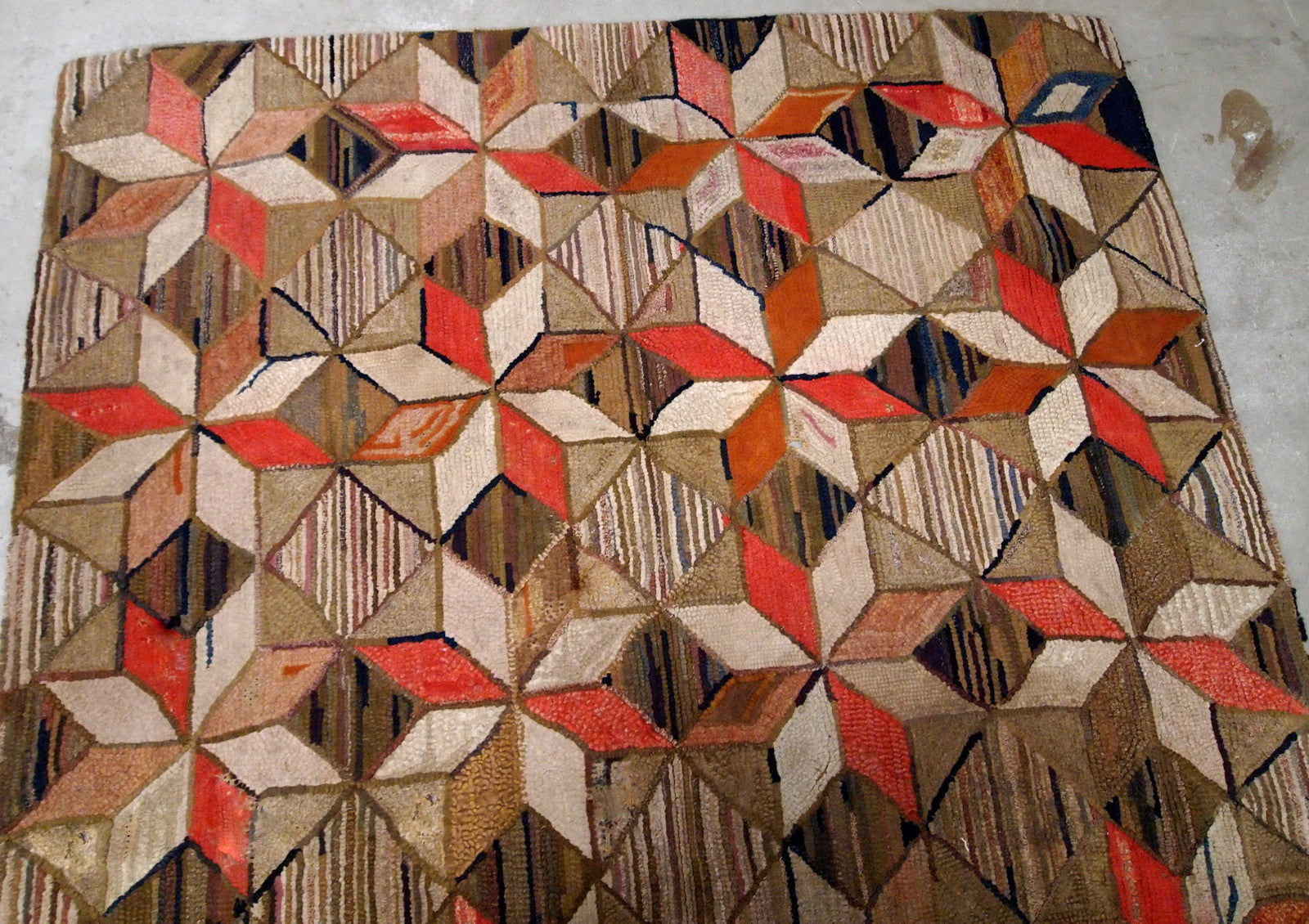 Antique handmade geometric American Hooked rug in brown, red, beige and olive shades. The rug has several holes, they has been restored, it is in good condition now.