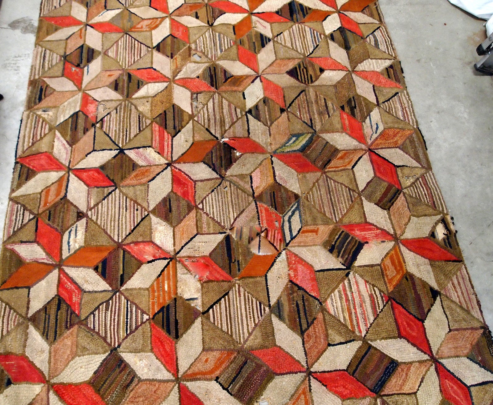 Antique handmade geometric American Hooked rug in brown, red, beige and olive shades. The rug has several holes, they has been restored, it is in good condition now.