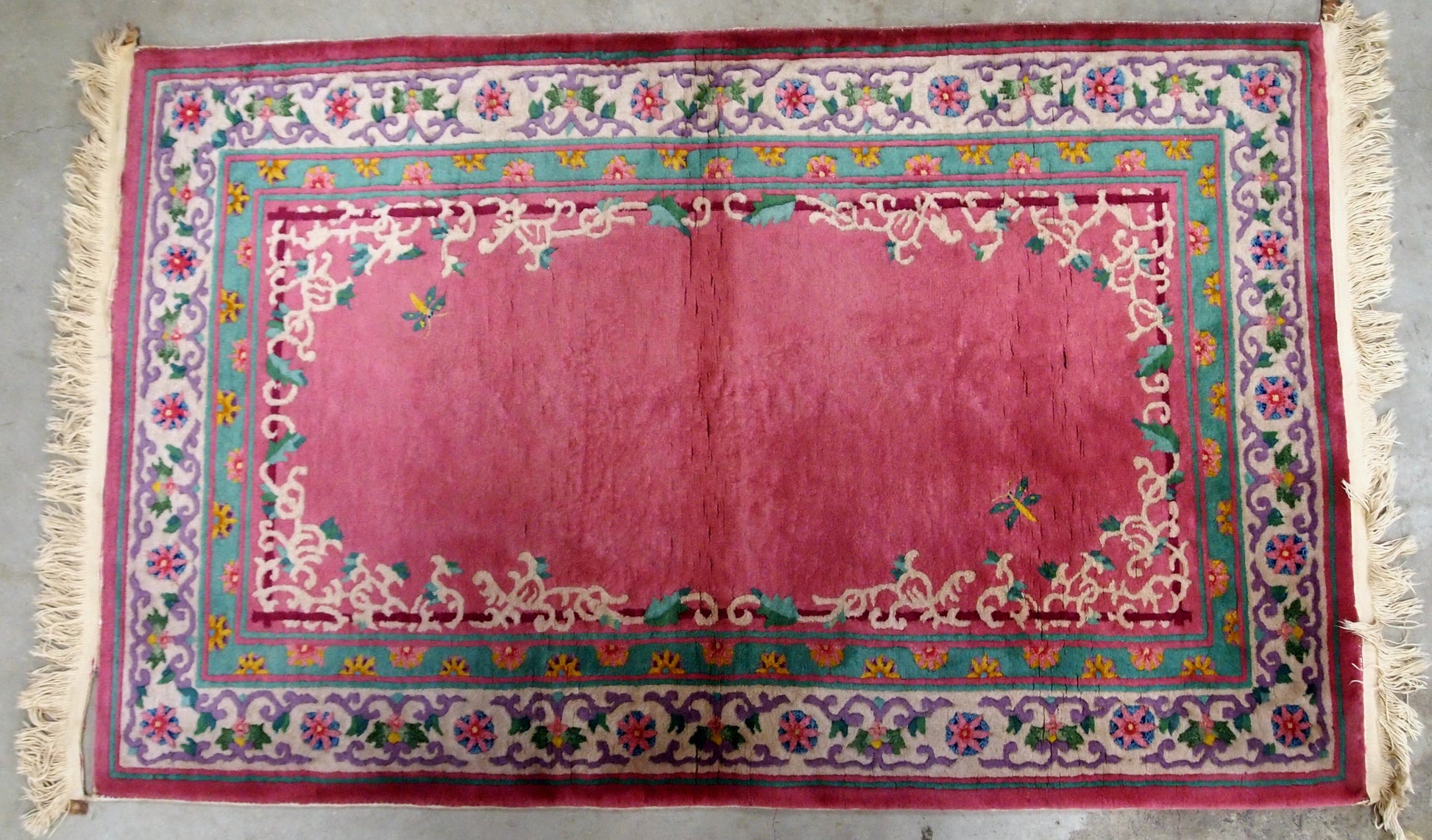 Handmade vintage Art Deco Chinese rug in fuchsia color and with all-over design. The rug is from 1930s, in original good condition.