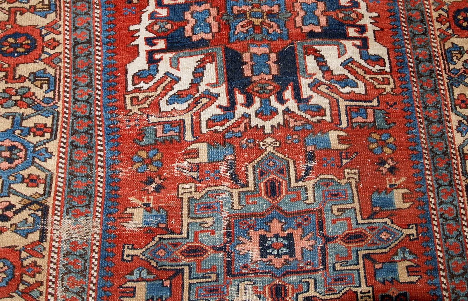 Antique Persian Heriz distressed rug in original condition. the rug made in classic design in red and blue shades It is from the end of 19th century.
