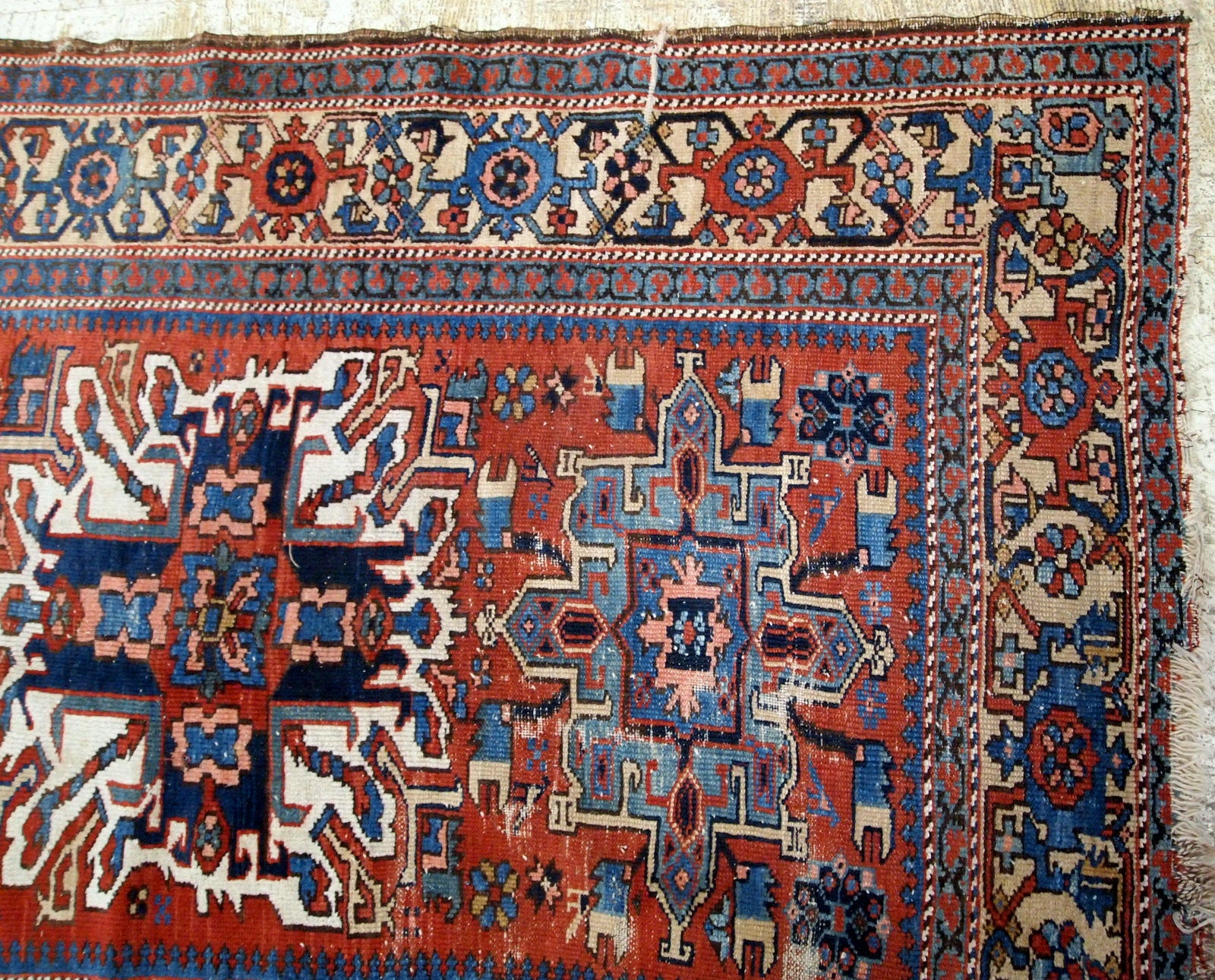 Antique Persian Heriz distressed rug in original condition. the rug made in classic design in red and blue shades It is from the end of 19th century.