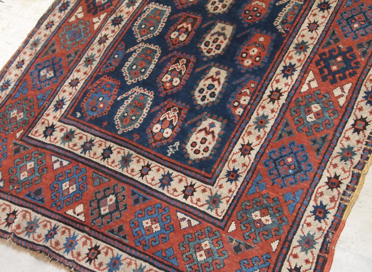 Handmade antique Caucasian Kazak rug in original good condition. This rug is from the end of 19th century made in unusual design.