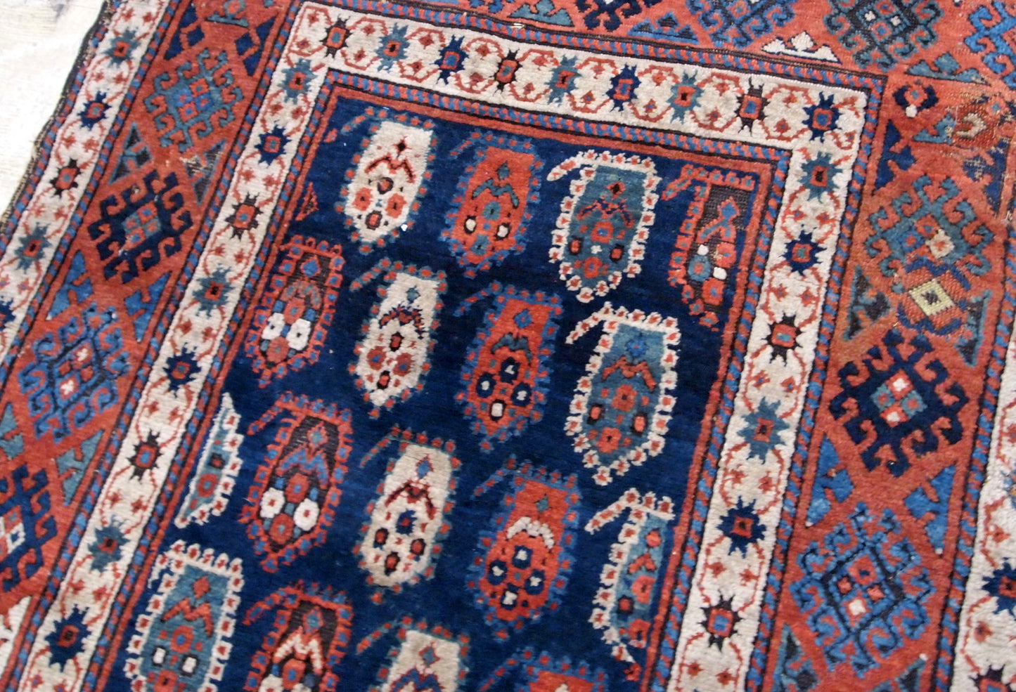 Handmade antique Caucasian Kazak rug in original good condition. This rug is from the end of 19th century made in unusual design.