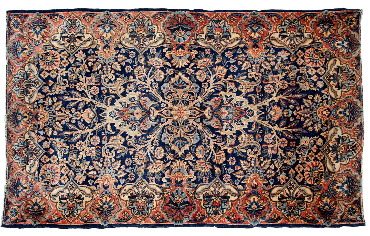 Antique handmade Kerman rug in navy blue shade with classic design. The rug is in original condition, has some low pile.