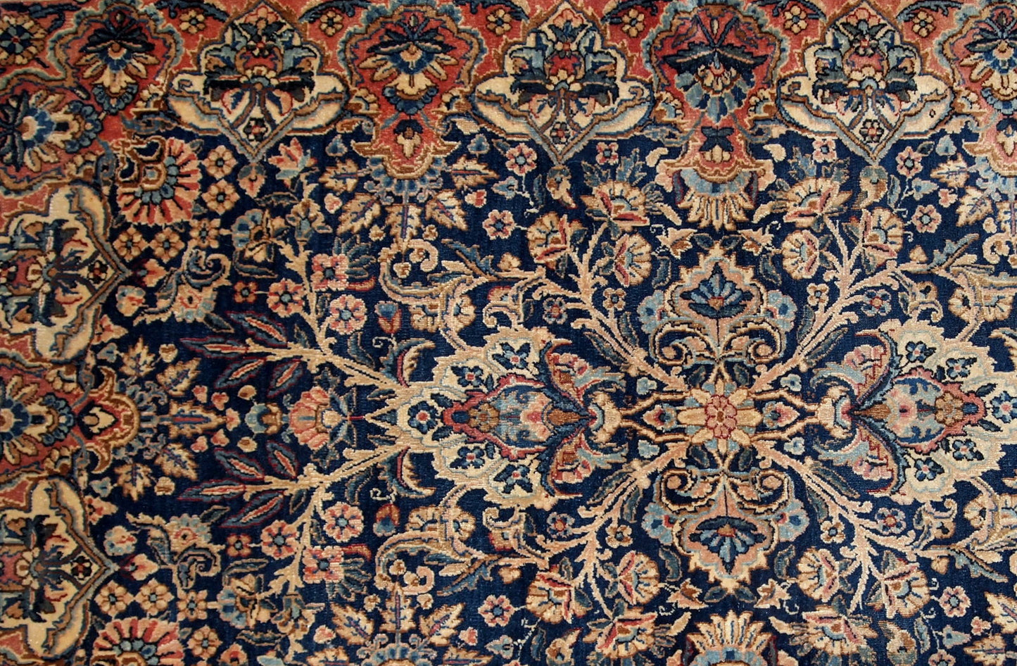 Antique handmade Kerman rug in navy blue shade with classic design. The rug is in original condition, has some low pile.