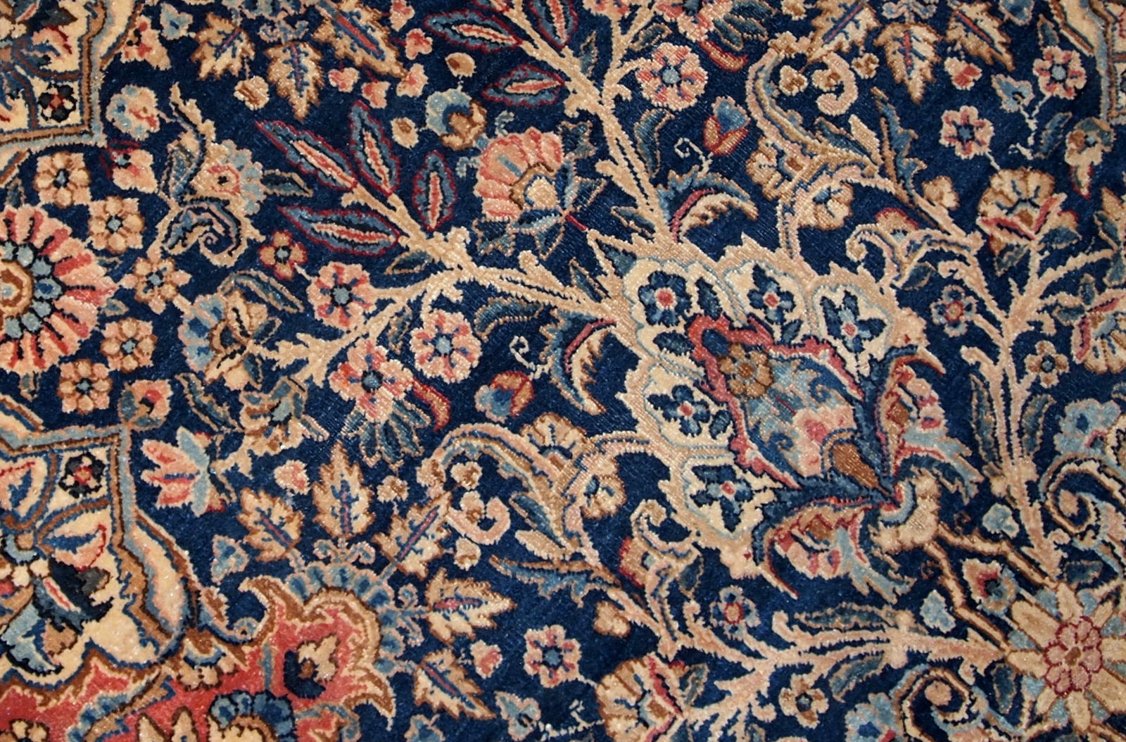 Antique handmade Kerman rug in navy blue shade with classic design. The rug is in original condition, has some low pile.