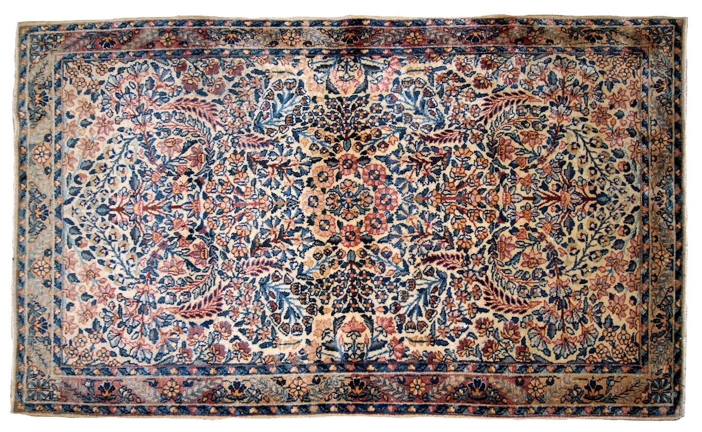 Hand made antique Kerman rug in original good condition from the beginning of 20th century. The rug in in beige shade and with classic floral design.