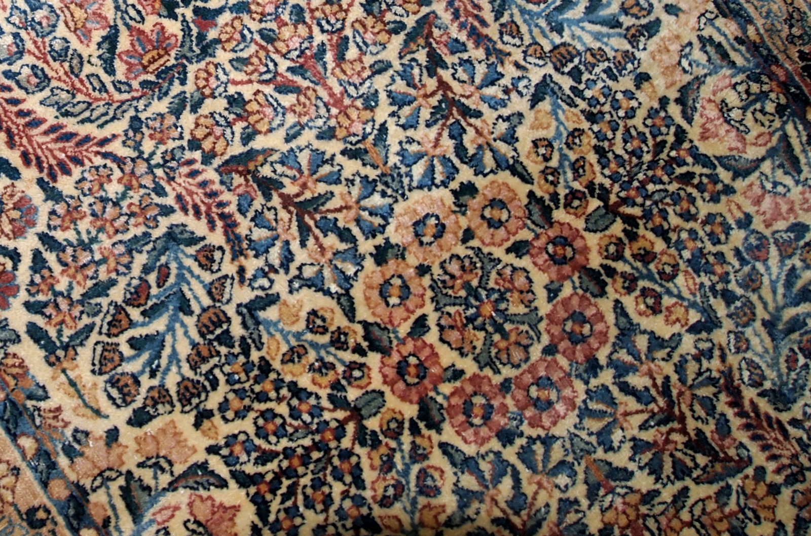 Hand made antique Kerman rug in original good condition from the beginning of 20th century. The rug in in beige shade and with classic floral design.