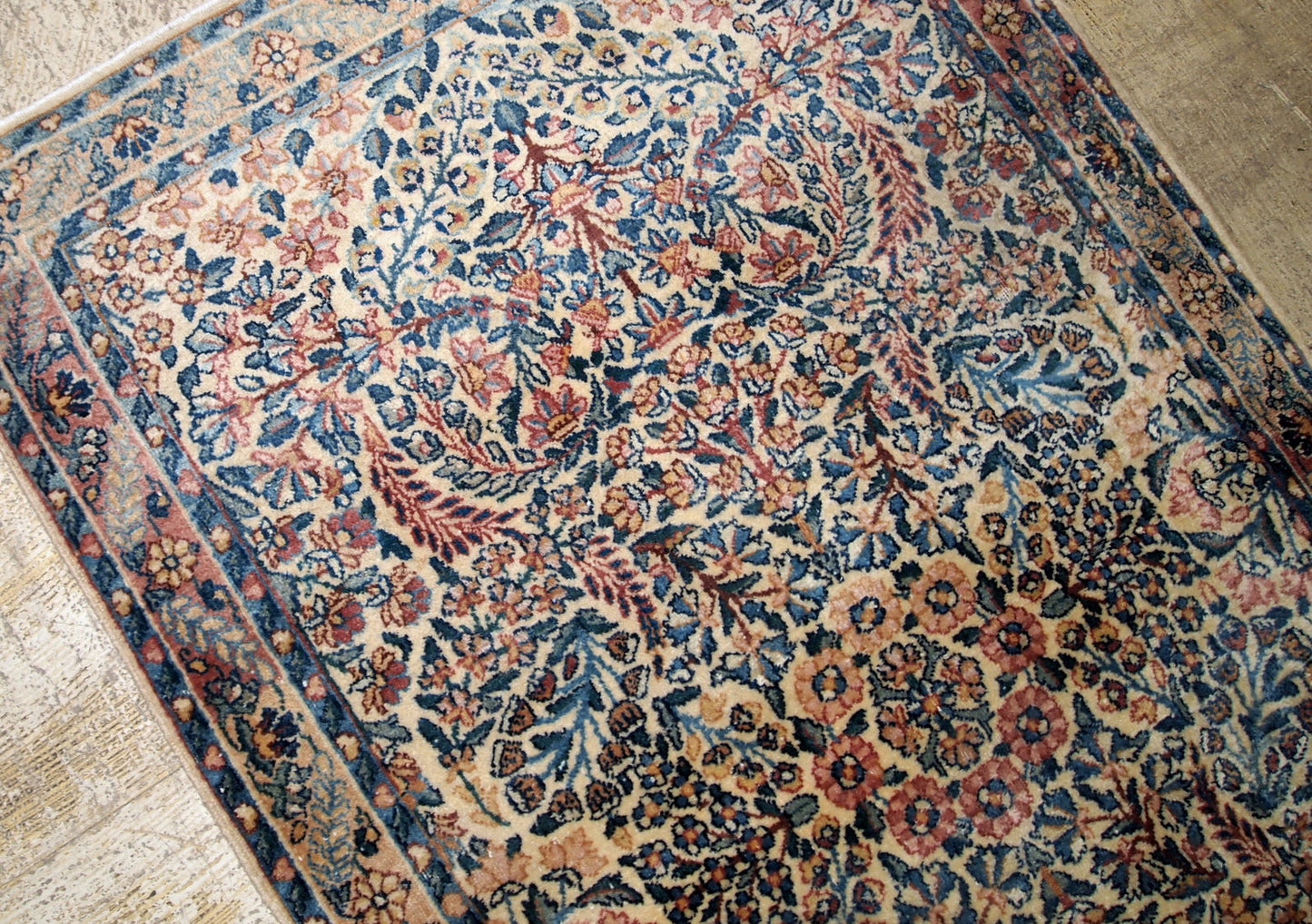 Hand made antique Kerman rug in original good condition from the beginning of 20th century. The rug in in beige shade and with classic floral design.