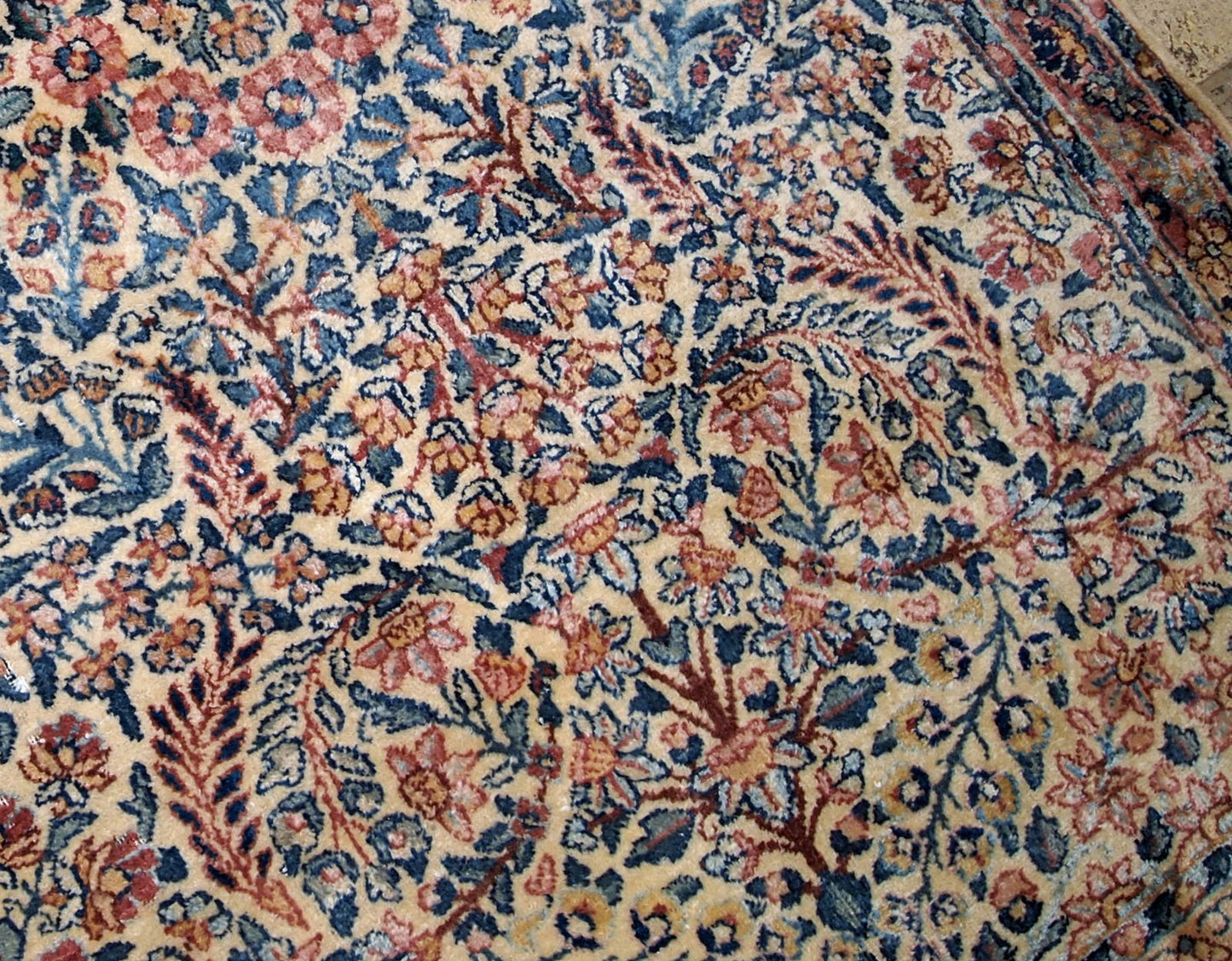 Hand made antique Kerman rug in original good condition from the beginning of 20th century. The rug in in beige shade and with classic floral design.