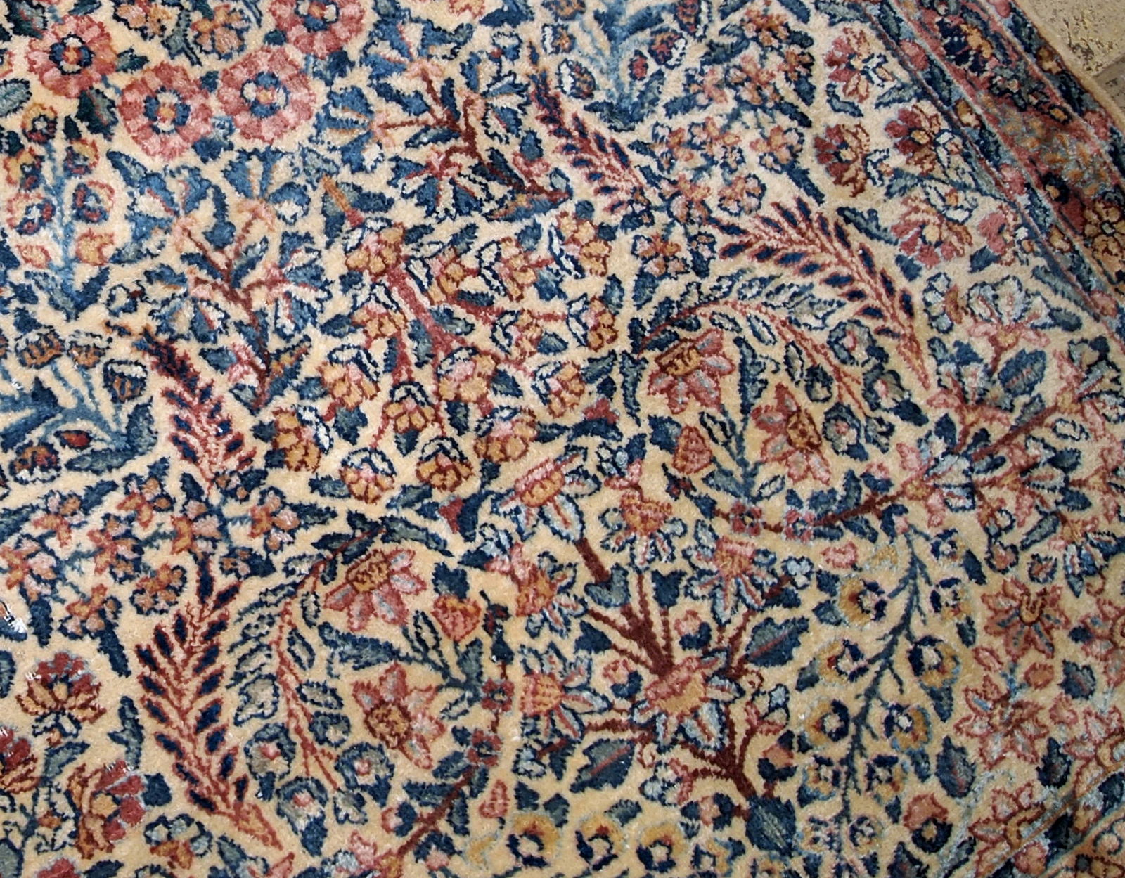 Hand made antique Kerman rug in original good condition from the beginning of 20th century. The rug in in beige shade and with classic floral design.