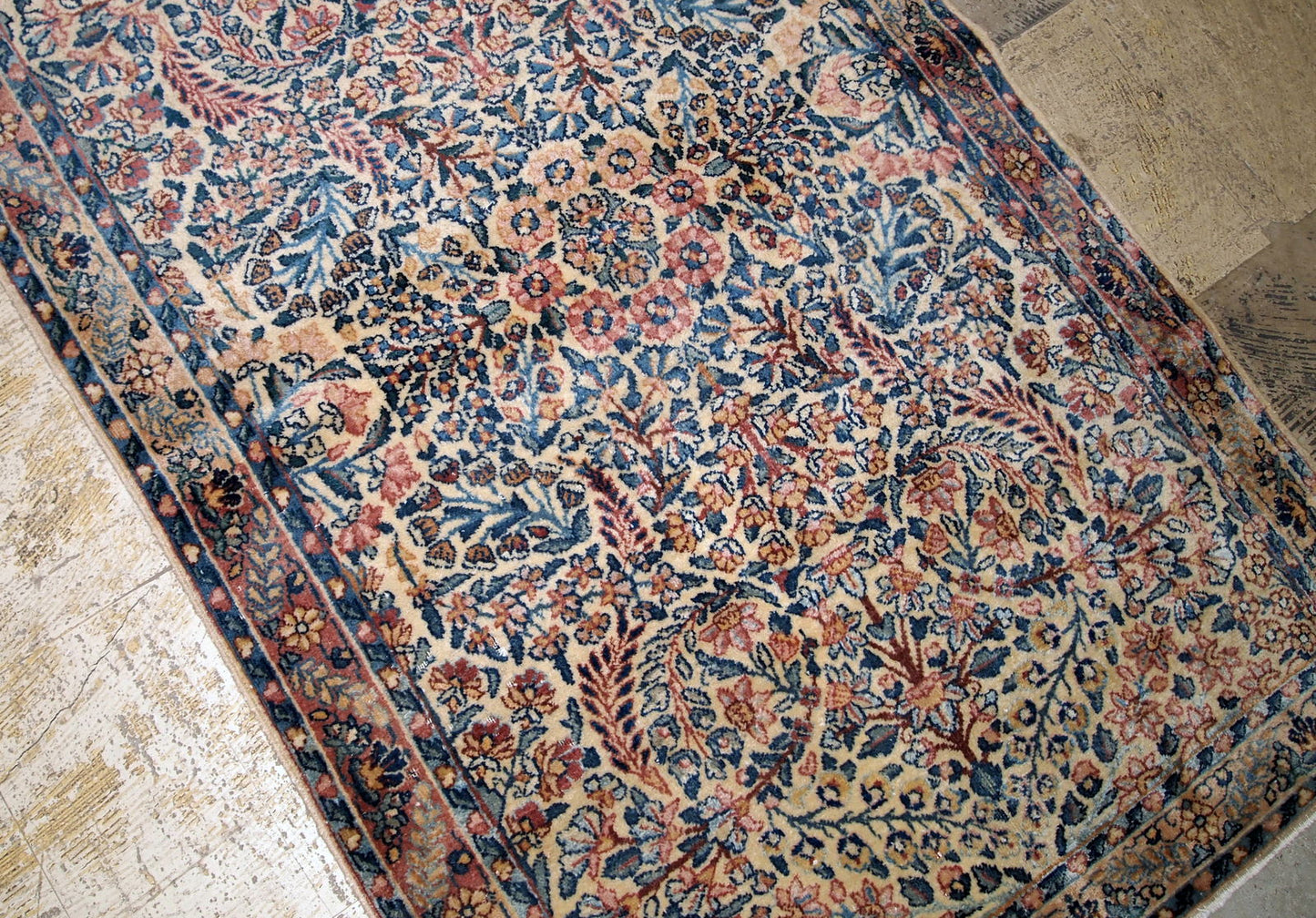 Hand made antique Kerman rug in original good condition from the beginning of 20th century. The rug in in beige shade and with classic floral design.