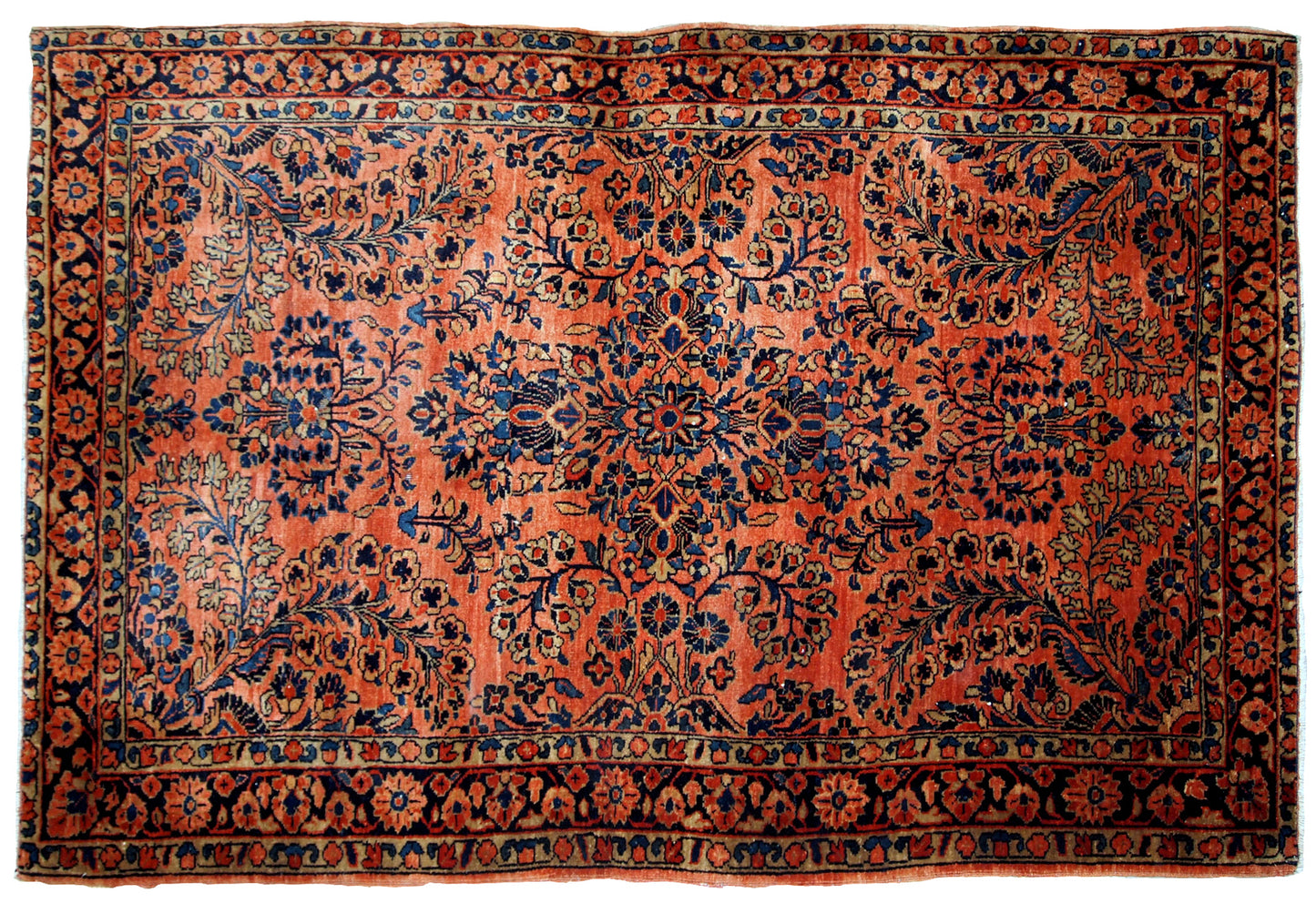 Antique Sarouk rug in red shade with classic floral design. The rug is from the beginning of 20th century in original good condition.